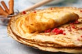 Delicious Russian pancakes with sour cream and honey cooked
