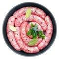 Delicious rustic raw  meat sausages in frying pan, with bay leaves and fresh herbs in the kitchen Royalty Free Stock Photo