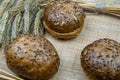 Delicious rye buns with ripe rye ears on burlap. hy food