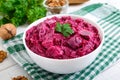 Delicious salad with boiled beets, herring, nuts, onions Royalty Free Stock Photo