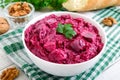 Delicious salad with boiled beets, herring, nuts, onions Royalty Free Stock Photo