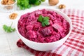 Delicious salad with boiled beets, herring, nuts, onions Royalty Free Stock Photo