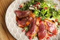 Delicious salad with roasted duck breast served on table, closeup Royalty Free Stock Photo