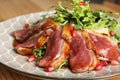 Delicious salad with roasted duck breast served on wooden table, closeup Royalty Free Stock Photo