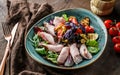 Delicious salad with sliced of turkey ham, grilled zucchini, tomatoes, basil, greens, olives and oil in bowl on wooden background Royalty Free Stock Photo