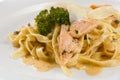 Delicious salmon pasta dish, tagliatelle noodles with Parmesan and parsley Royalty Free Stock Photo