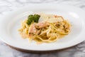 Delicious salmon pasta dish, tagliatelle noodles with Parmesan and parsley Royalty Free Stock Photo