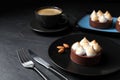 Delicious salted caramel chocolate tart with meringue and almonds on black table Royalty Free Stock Photo