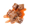 Delicious salted caramel with sauce on white background, top view