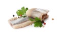 Delicious salted herring fillets with parsley and peppercorns on white background Royalty Free Stock Photo