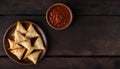 Delicious Samosas on Plate with Sauce and Wooden Background, Copy Space