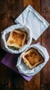 Delicious sandwich in golden brown crust, purple napkin on wooden table