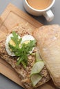 Delicious sandwich with tuna, boiled egg, vegetables and cup of tea on light grey table, flat lay Royalty Free Stock Photo