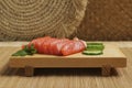 Delicious sashimi set of salmon and shrimps served with cucumbers and parsley on bamboo mat