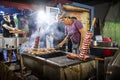 Delicious sausages and chicken grilled on charcoal during Santa Iria Fair in Faro, Algarve, Portugal