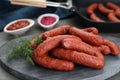 Delicious sausages and dill on grey table