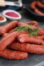 Delicious sausages and dill on grey table, closeup