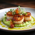 Delicious scallops with pea and mint puree, topped with crispy fried shallots and microgreens Royalty Free Stock Photo