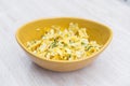 Delicious scrambled eggs with parsley in a mustard yellow bowl