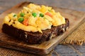 Scrambled eggs omelette idea. Home scrambled eggs omelette with vegetables on rye bread toasts. Healthy eating to lose weight. Rus Royalty Free Stock Photo