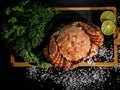 Delicious seafood. Crab with greens and lime on wooden desk. Horisontal shot. Close-up. Top view