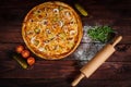 Delicious seafood shrimps and mussels pizza on a black wooden table. Italian food. Top view Royalty Free Stock Photo
