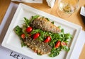 Delicious seared fish fillet with wine on restaurant background