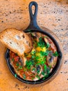 delicious shakshuka - fried eggs, onion, bell pepper, tomatoes, chili Royalty Free Stock Photo