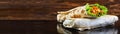 Delicious shawarma sandwich on wooden background. Banner