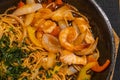 Delicious shrimp and onion spaghetti in sizzling iron platter