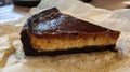 Slice of Delicious Burnt Basque Cheesecake on White Paper at Cafe Royalty Free Stock Photo
