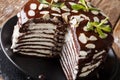 Delicious sliced chocolate crepes cake with whipped cream and al