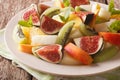 Delicious sliced fruit fig, peach, melon, kiwi and orange close- Royalty Free Stock Photo