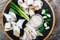 Delicious sliced pork fat with spices, green onions, garlic and sauce on cutting board on wooden background Royalty Free Stock Photo