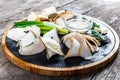 Delicious sliced pork fat with spices, green onions, garlic and sauce on cutting board on wooden background Royalty Free Stock Photo