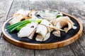 Delicious sliced pork fat with spices, green onions, garlic and sauce on cutting board on wooden background close up Royalty Free Stock Photo