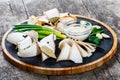 Delicious sliced pork fat with spices, green onions, garlic and sauce on cutting board on wooden background Royalty Free Stock Photo