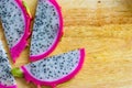 Delicious slices of pitaya fruit on top of wood