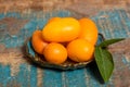 Delicious small citrus fruits kumquats close up on wooden table