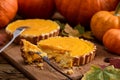 Delicious small pumpkin pies being cut and eaten with forks on w