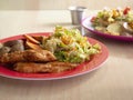 Smoked Grilled Chicken with BBQ Sauce and a mix of Potatoes and Sweet Potatoes and Green Salad with Yellow Corn Royalty Free Stock Photo