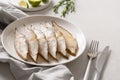 Delicious smoked halibut slices served in white plate