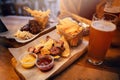 Delicious smoked sausage with chips, french fries and steak with Royalty Free Stock Photo