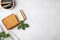 Delicious smoked tofu, soy sauce and basil on tiled table, flat lay. Space for text Royalty Free Stock Photo