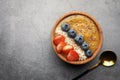 Delicious smoothie bowl with fresh berries, chia seeds and coconut flakes on grey table, flat lay. Space for text Royalty Free Stock Photo