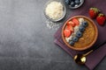Delicious smoothie bowl with fresh berries, chia seeds and coconut flakes on grey table, flat lay. Space for text Royalty Free Stock Photo
