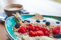 Delicious smoothie bowl with strawberries, banana, blueberries, apple and granola on summer background Royalty Free Stock Photo