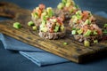 Delicious snacks with bread, avocado and tomato on the board. The concept of healthy food, vegetarianism