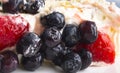 Biscuit cake with butter cream and fresh strawberries and blueberries Royalty Free Stock Photo