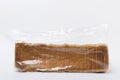 Delicious soft browned bread for toasts in the plasic bag, white background